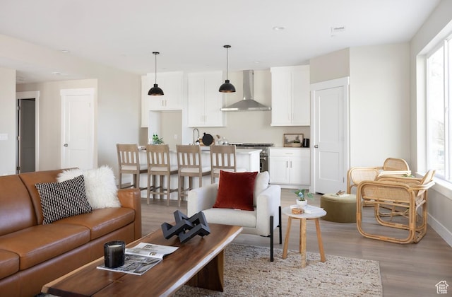 1562 E 3900 S Unit 107, Millcreek, UT 84124 - living area featuring light wood-style flooring and baseboards