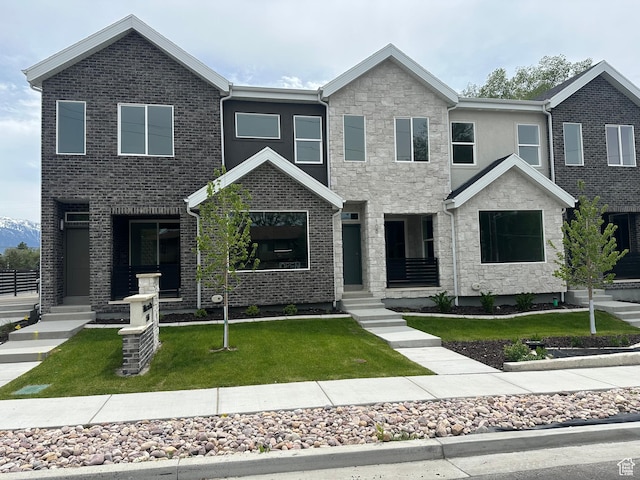 1562 E 3900 S Unit 107, Millcreek, UT 84124 - view of front of home with a front yard and stone siding