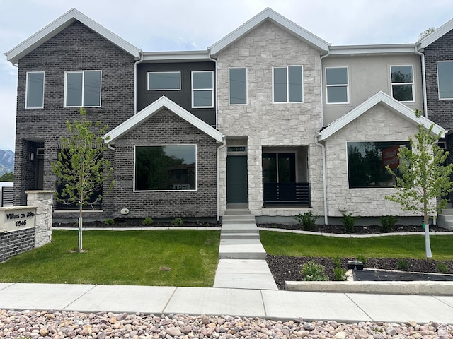 1562 E 3900 S Unit 107, Millcreek, UT 84124 - view of front of home with stone siding and a front yard
