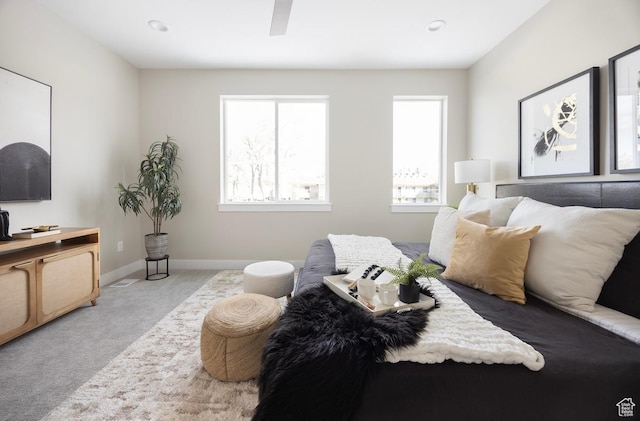 1562 E 3900 S Unit 107, Millcreek, UT 84124 - bedroom featuring carpet flooring, multiple windows, baseboards, and a ceiling fan
