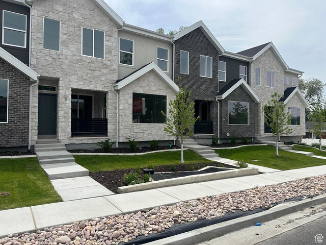 1562 E 3900 S Unit 107, Millcreek, UT 84124 - view of front of property with stone siding and a front lawn