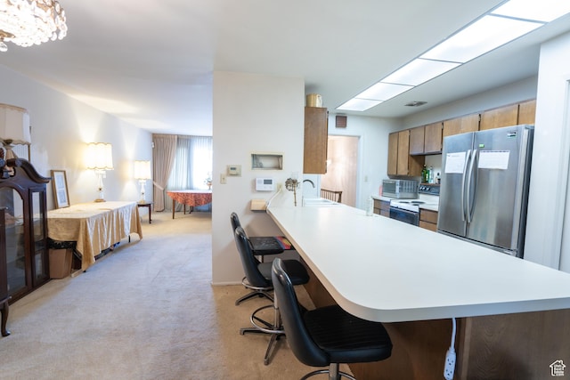 4971 S Beaver Brook Ln E Unit 40, Murray, UT 84117 - kitchen featuring freestanding refrigerator, light countertops, electric range oven, and light colored carpet