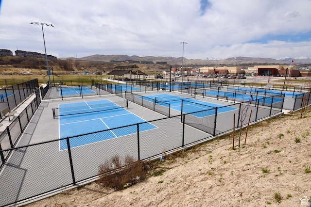 view of sport court with fence and a mountain view