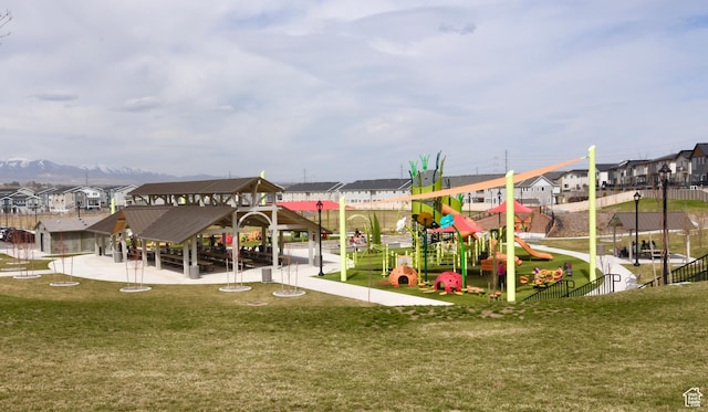 community playground featuring a residential view and a yard
