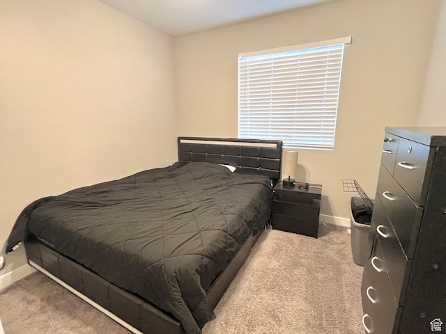carpeted bedroom featuring baseboards