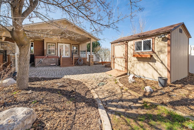 exterior space with french doors, an outbuilding, and a porch