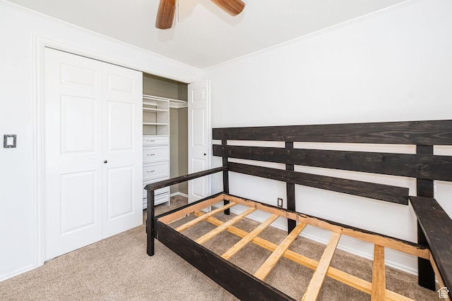 carpeted bedroom with a closet and a ceiling fan