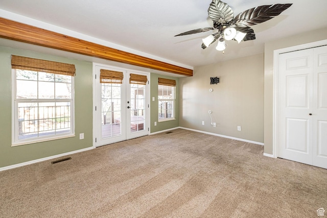 unfurnished room with french doors, carpet flooring, a ceiling fan, baseboards, and visible vents