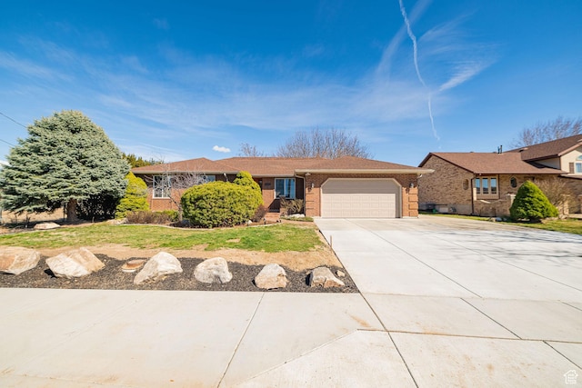 single story home with brick siding, a front yard, driveway, and a garage
