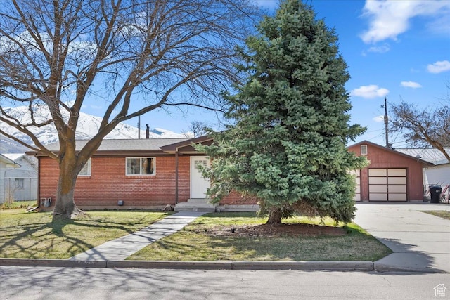 view of front of house with driveway, a front yard, a garage, and brick siding