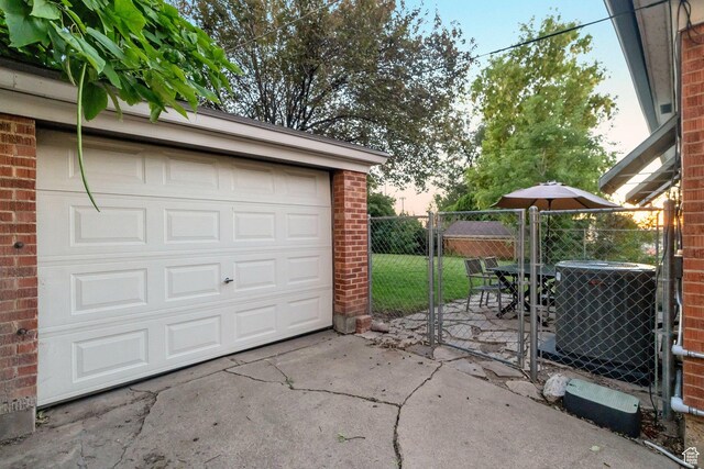 1311 E 29th St S, Ogden, UT 84403 - garage with a gate, fence, central AC, and concrete driveway