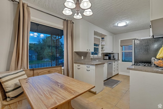 1311 E 29th St S, Ogden, UT 84403 - kitchen featuring white cabinetry, freestanding refrigerator, an inviting chandelier, a sink, and dishwasher