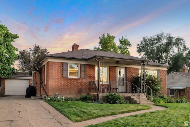 1311 E 29th St S, Ogden, UT 84403 - bungalow-style home with a lawn, an outbuilding, and brick siding