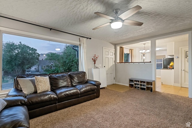 1311 E 29th St S, Ogden, UT 84403 - living room with light tile patterned flooring, a textured ceiling, baseboards, ceiling fan with notable chandelier, and light colored carpet