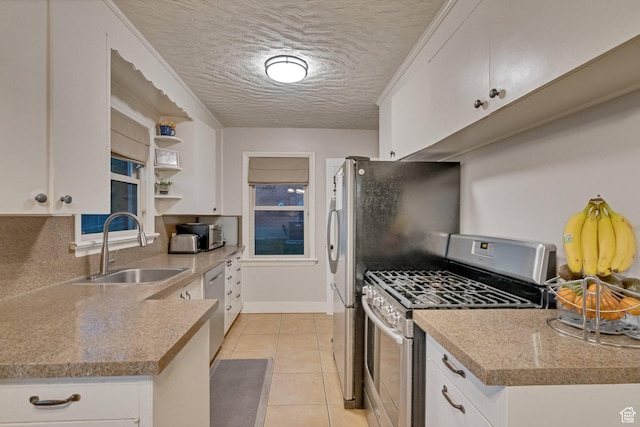 1311 E 29th St S, Ogden, UT 84403 - kitchen featuring white cabinets, a sink, stainless steel appliances, and a textured ceiling