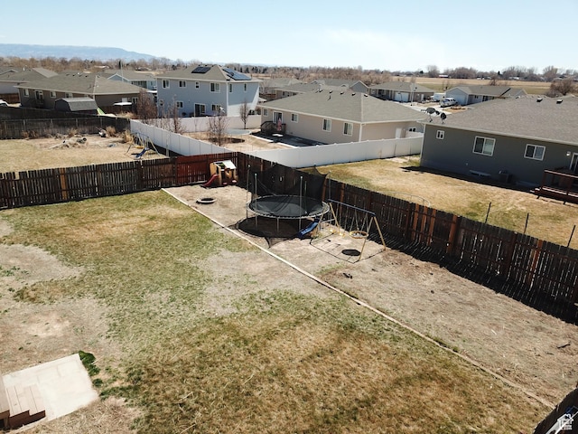1451 W 925 S, Vernal, UT 84078 - view of yard featuring a trampoline, a fenced backyard, and a residential view