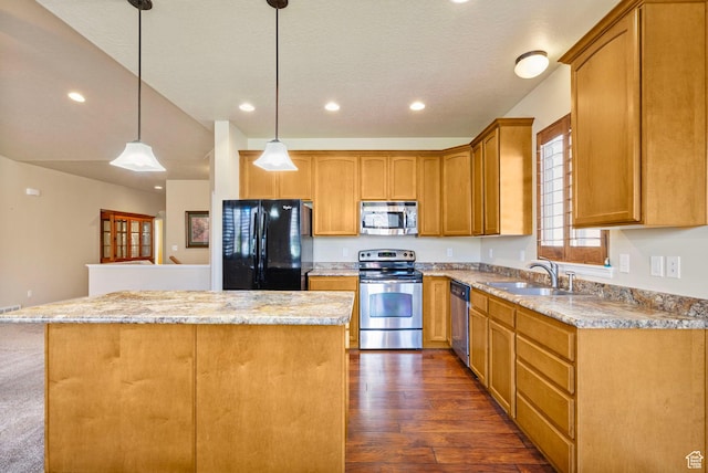 kitchen featuring decorative light fixtures, stainless steel appliances, a kitchen island, a sink, and dark wood-style floors