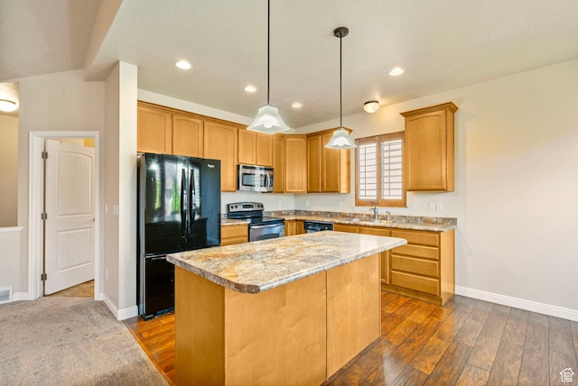 kitchen with dark wood-type flooring, light countertops, a center island, and appliances with stainless steel finishes