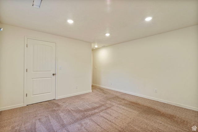 spare room with baseboards, recessed lighting, and carpet