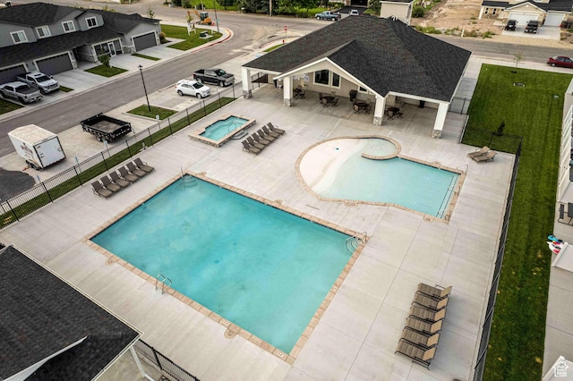 community pool with fence, a gazebo, a community hot tub, and a patio area