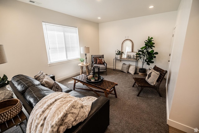 carpeted living area featuring baseboards, recessed lighting, and visible vents