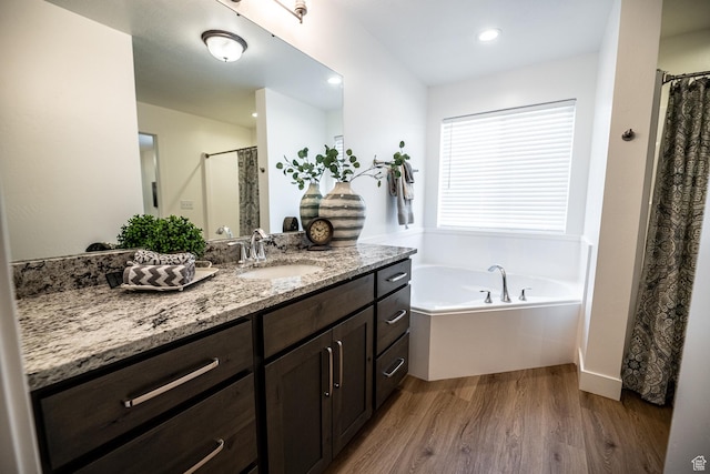 full bath with vanity, recessed lighting, wood finished floors, a shower with curtain, and a bath