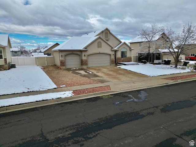 1519 N 2340 W, Clinton, UT 84015 - view of front of house featuring a gate, fence, an attached garage, concrete driveway, and stucco siding