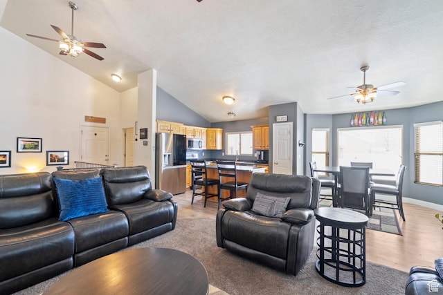 1519 N 2340 W, Clinton, UT 84015 - living area featuring light wood finished floors, a ceiling fan, and plenty of natural light
