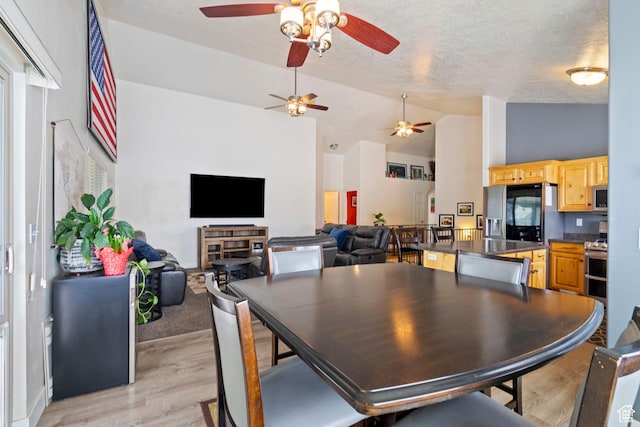 1519 N 2340 W, Clinton, UT 84015 - dining room featuring a textured ceiling, ceiling fan, high vaulted ceiling, and light wood-type flooring