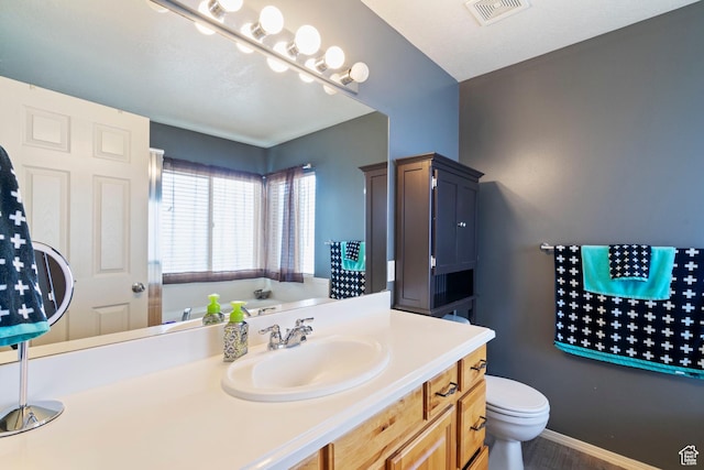 1519 N 2340 W, Clinton, UT 84015 - bathroom featuring toilet, vanity, baseboards, and visible vents