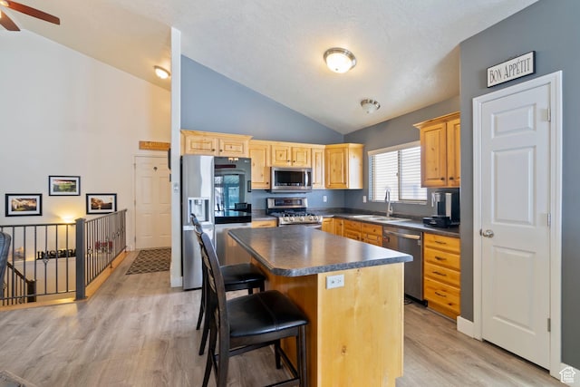 1519 N 2340 W, Clinton, UT 84015 - kitchen with a kitchen breakfast bar, stainless steel appliances, a sink, dark countertops, and ceiling fan