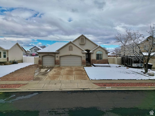 1519 N 2340 W, Clinton, UT 84015 - view of front of home with driveway, stucco siding, fence, and an attached garage