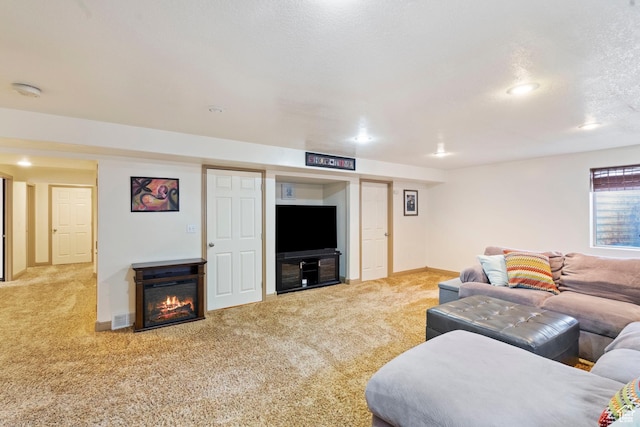 1519 N 2340 W, Clinton, UT 84015 - living room featuring carpet, baseboards, a textured ceiling, visible vents, and a glass covered fireplace
