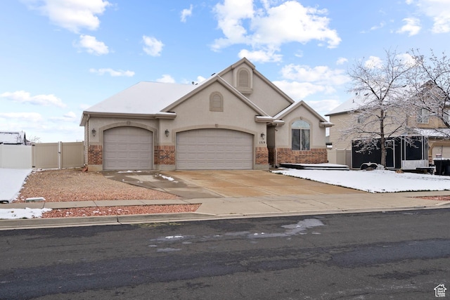 1519 N 2340 W, Clinton, UT 84015 - view of front of house with driveway, fence, a gate, a garage, and stucco siding