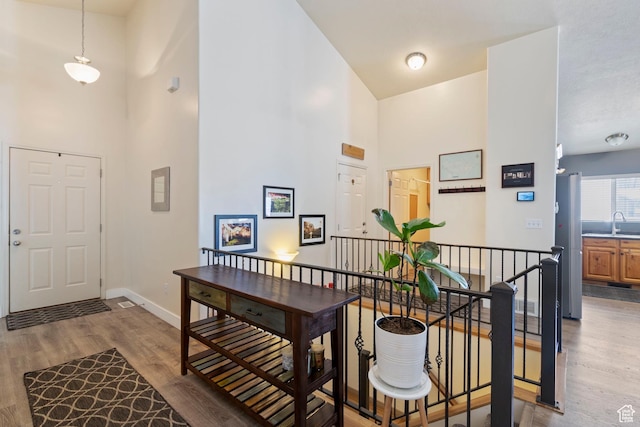 1519 N 2340 W, Clinton, UT 84015 - foyer entrance featuring a high ceiling, light wood-style flooring, and baseboards