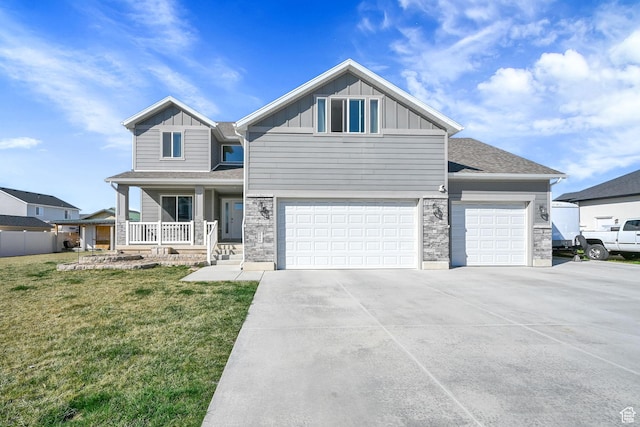craftsman house featuring concrete driveway, stone siding, board and batten siding, a front yard, and a porch