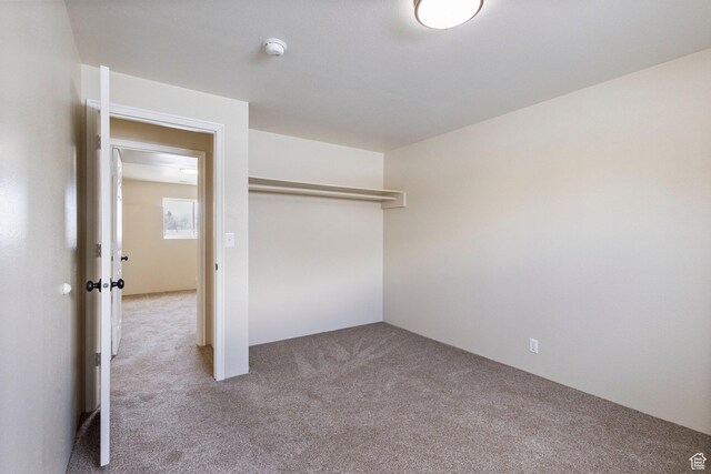 unfurnished bedroom featuring a closet and carpet