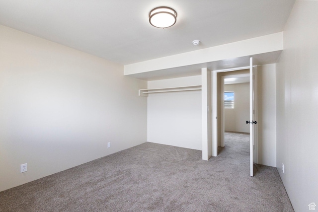 unfurnished bedroom featuring a closet and carpet
