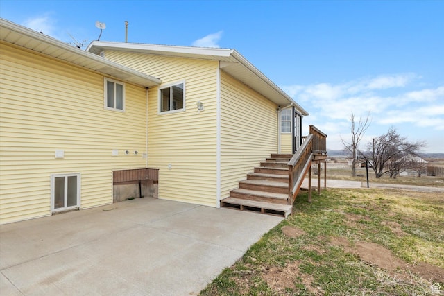 view of property exterior with a patio area
