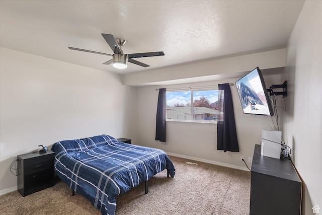 carpeted bedroom with baseboards, visible vents, and ceiling fan