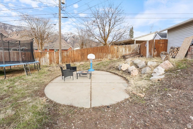 view of patio / terrace with a trampoline and a fenced backyard