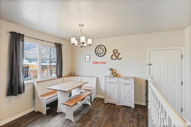 dining area featuring a notable chandelier, dark wood-style floors, and baseboards