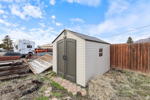 view of shed with fence