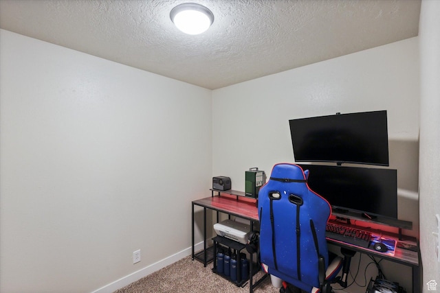 home office with carpet, baseboards, and a textured ceiling