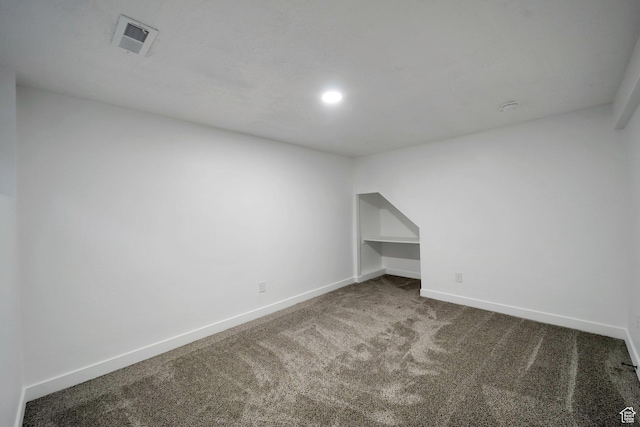 spare room featuring baseboards, visible vents, recessed lighting, and carpet