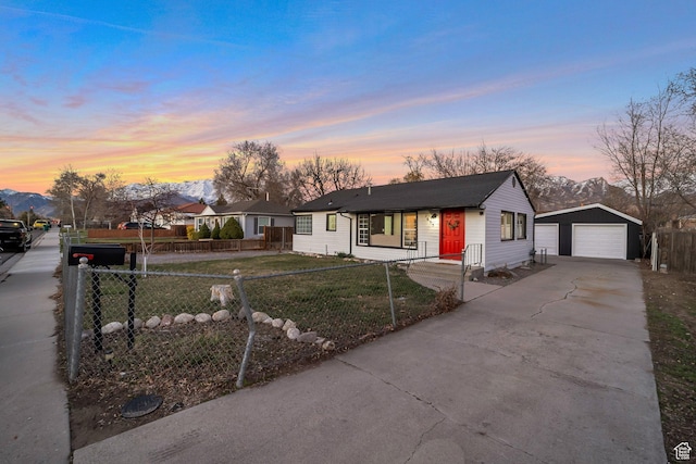 view of front of house with a lawn, an outbuilding, fence, and a garage