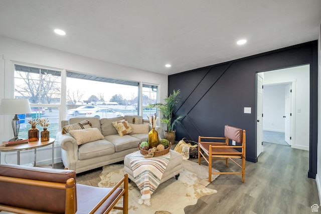 living area featuring baseboards, wood finished floors, and recessed lighting