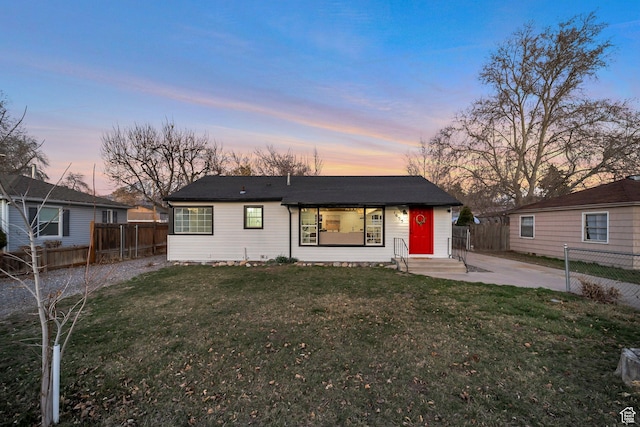 view of front facade featuring a front yard and fence