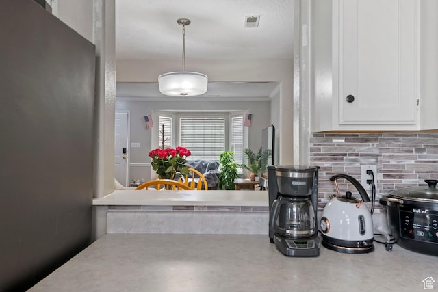 962 N Independence W, Provo, UT 84604 - kitchen with light countertops, white cabinets, visible vents, and decorative backsplash