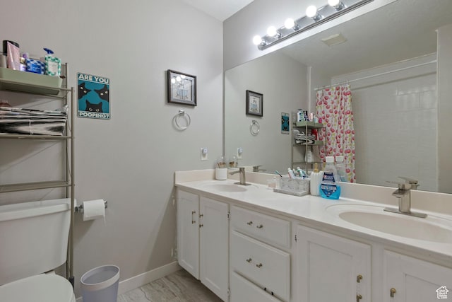 962 N Independence W, Provo, UT 84604 - bathroom with double vanity, toilet, baseboards, and a sink